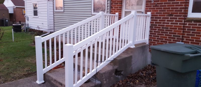 A white railing on the side of a house.